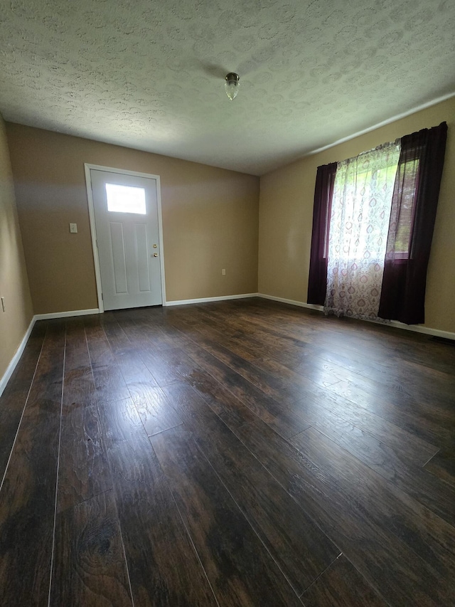 438 Ky Highway 455, Sparta, KY 41086 - empty room featuring plenty of natural light, dark wood finished floors, a textured ceiling, and baseboards