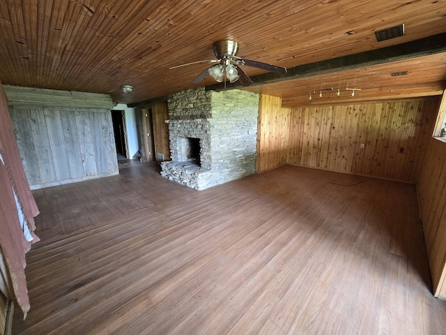 438 Ky Highway 455, Sparta, KY 41086 - unfurnished living room with ceiling fan, wood finished floors, a fireplace, wood walls, and wood ceiling