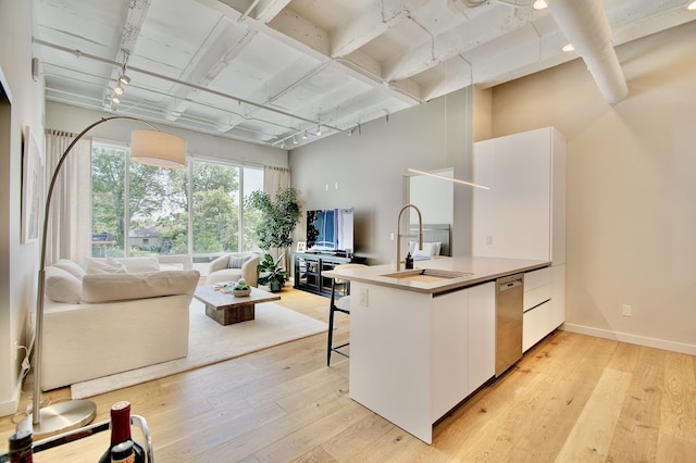 120 Main St Unit 205, Newport, KY 41071 - kitchen featuring dishwasher, a sink, rail lighting, white cabinetry, and light wood-style floors