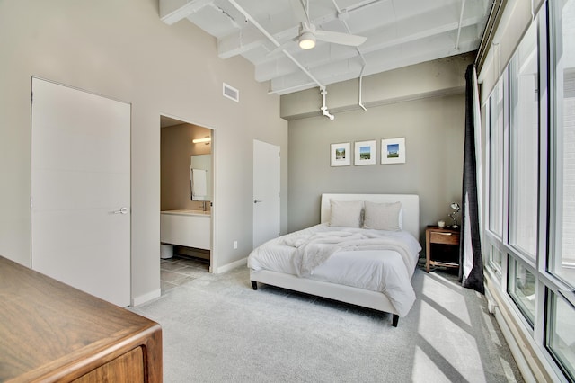 120 Main St Unit 205, Newport, KY 41071 - bedroom with light colored carpet, a towering ceiling, beamed ceiling, baseboards, and connected bathroom