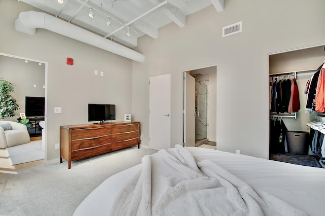 120 Main St Unit 205, Newport, KY 41071 - carpeted bedroom featuring a towering ceiling, a walk in closet, a closet, beam ceiling, and baseboards