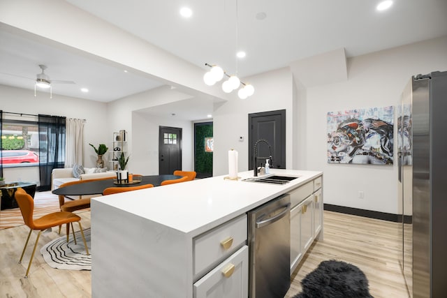 213 8th Ave, Dayton, KY 41074 - kitchen with a sink, appliances with stainless steel finishes, light wood-style floors, light countertops, and recessed lighting