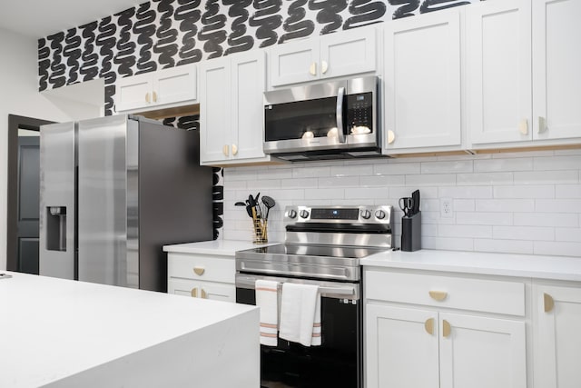 213 8th Ave, Dayton, KY 41074 - kitchen with appliances with stainless steel finishes, light countertops, backsplash, and white cabinets