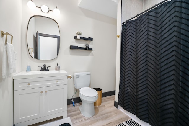 213 8th Ave, Dayton, KY 41074 - bathroom featuring toilet, wood finished floors, vanity, curtained shower, and baseboards