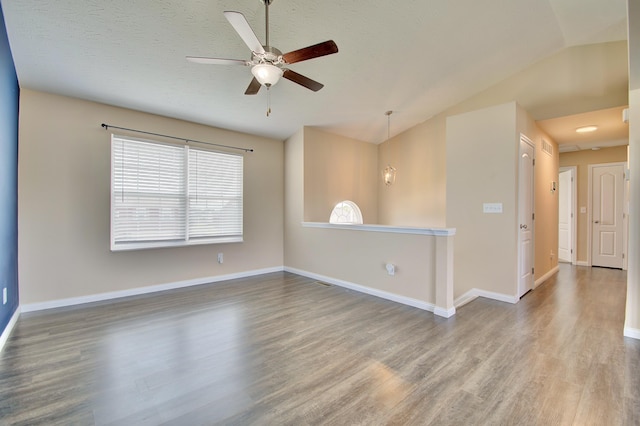 609 Crosswinds Pointe Ct, Walton, KY 41094 - empty room featuring vaulted ceiling, wood finished floors, ceiling fan, and baseboards