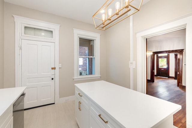 436 Elm St, Ludlow, KY 41016 - kitchen featuring light countertops, dishwasher, white cabinets, baseboards, and a chandelier