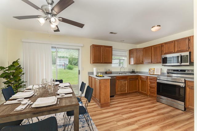 5332 Country Club Ln Unit 5C, Burlington, KY 41005 - kitchen featuring stainless steel appliances, brown cabinets, and light wood-style flooring