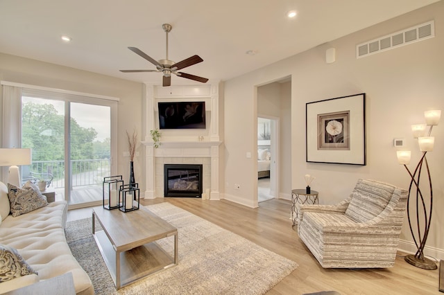 3942 Brunswick Ct, Erlanger, KY 41018 - living room featuring ceiling fan, light wood finished floors, baseboards, a tiled fireplace, and recessed lighting