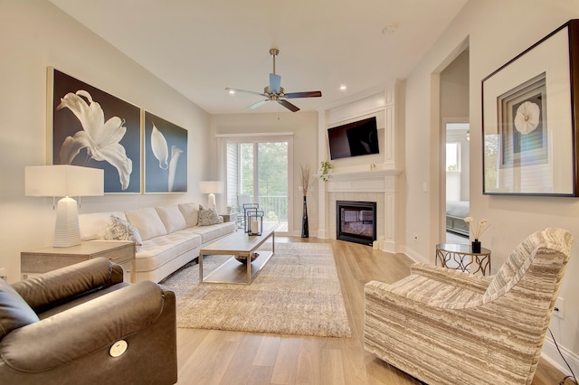 3942 Brunswick Ct, Erlanger, KY 41018 - living room featuring a ceiling fan, wood finished floors, a tiled fireplace, baseboards, and recessed lighting
