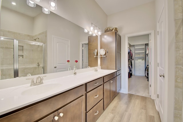 3942 Brunswick Ct, Erlanger, KY 41018 - full bathroom with double vanity, a stall shower, wood finished floors, and a spacious closet
