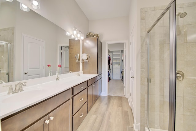 3942 Brunswick Ct, Erlanger, KY 41018 - bathroom with a stall shower, double vanity, wood finished floors, and a spacious closet