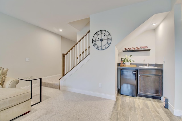 3942 Brunswick Ct, Erlanger, KY 41018 - indoor wet bar with black refrigerator, stairway, baseboards, recessed lighting, and light wood-style flooring