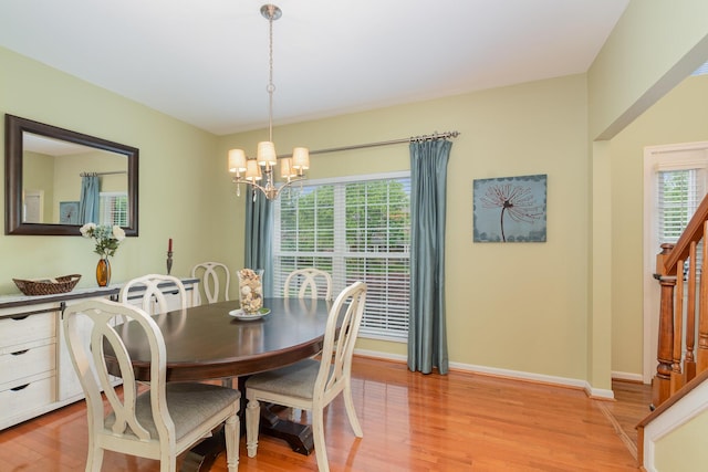 4049 Sherbourne Dr, Independence, KY 41051 - dining area featuring a chandelier, light wood finished floors, baseboards, and stairs