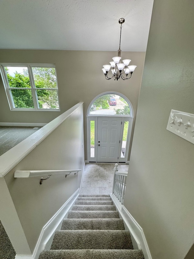 1039 Meadowbrook Ct, Hebron, KY 41048 - staircase featuring carpet floors, a chandelier, and baseboards