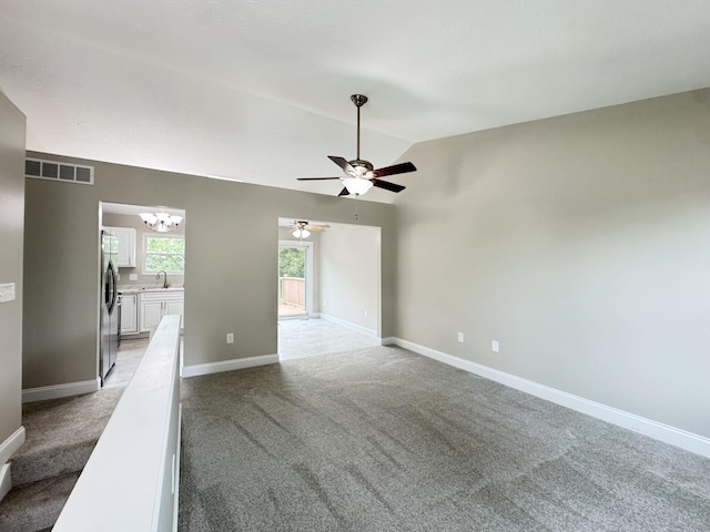 1039 Meadowbrook Ct, Hebron, KY 41048 - empty room featuring vaulted ceiling, light colored carpet, a chandelier, a ceiling fan, and baseboards
