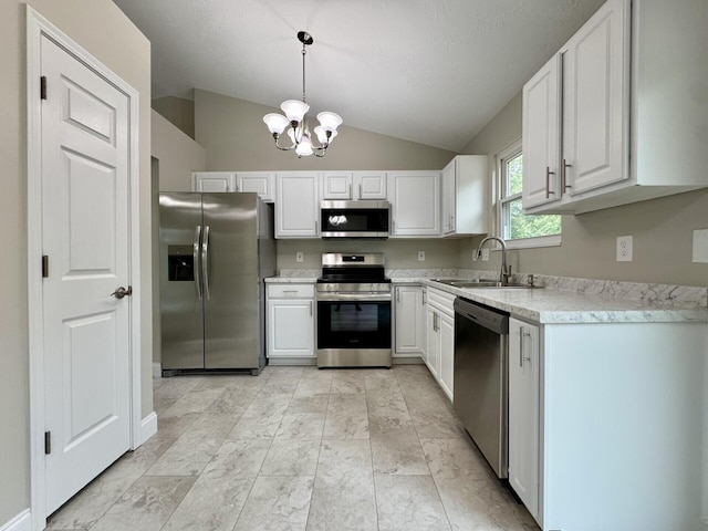 1039 Meadowbrook Ct, Hebron, KY 41048 - kitchen with appliances with stainless steel finishes, vaulted ceiling, a sink, light countertops, and a chandelier