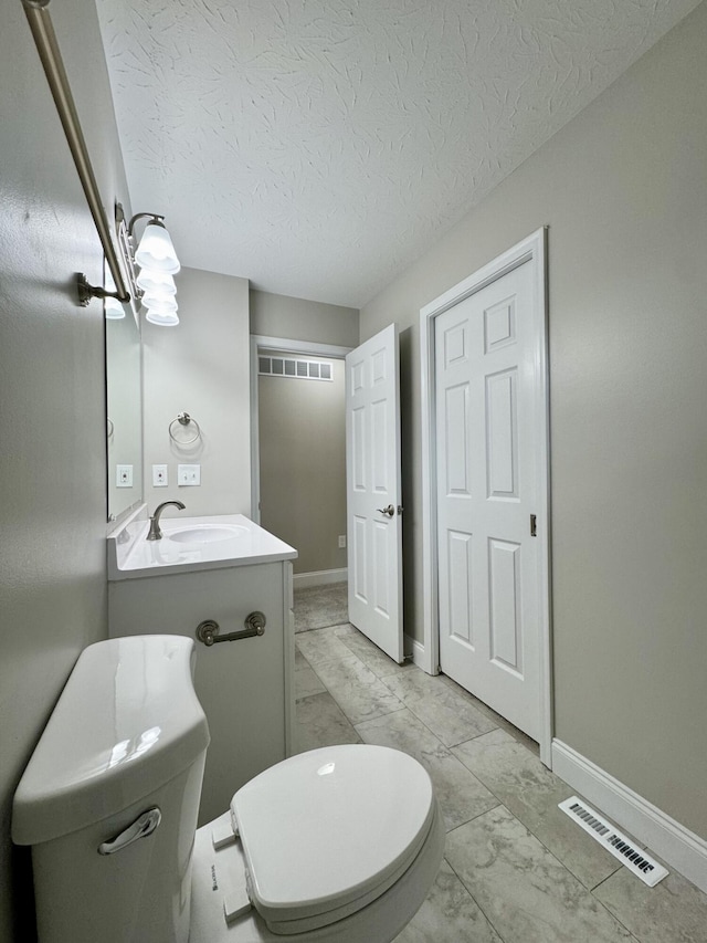 1039 Meadowbrook Ct, Hebron, KY 41048 - bathroom with toilet, vanity, baseboards, marble finish flooring, and a textured ceiling