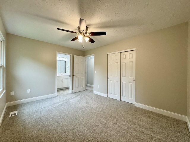1039 Meadowbrook Ct, Hebron, KY 41048 - unfurnished bedroom with a closet, light colored carpet, baseboards, and a textured ceiling