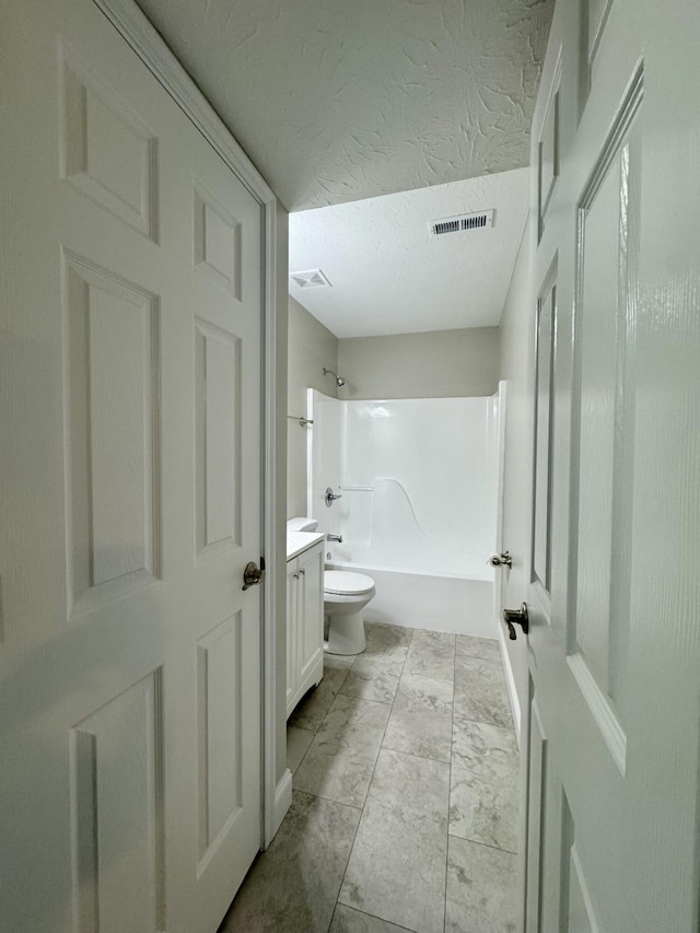 1039 Meadowbrook Ct, Hebron, KY 41048 - bathroom featuring toilet, vanity, washtub / shower combination, and a textured ceiling