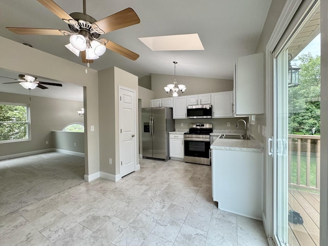 1039 Meadowbrook Ct, Hebron, KY 41048 - kitchen featuring appliances with stainless steel finishes, a skylight, a sink, light countertops, and a chandelier