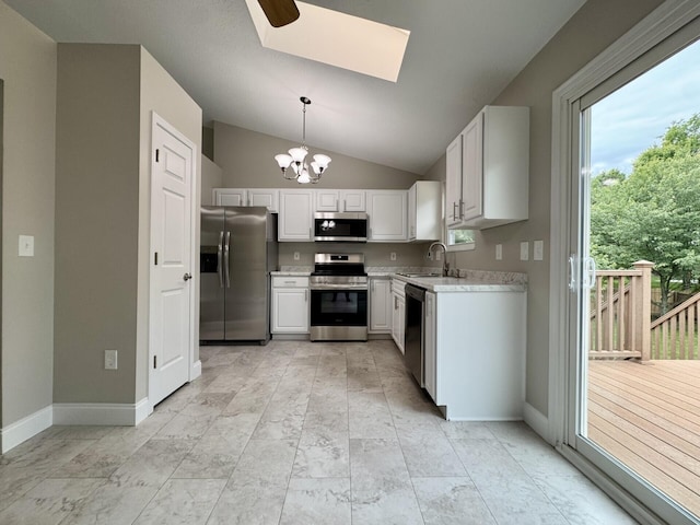 1039 Meadowbrook Ct, Hebron, KY 41048 - kitchen with stainless steel appliances, a sink, a chandelier, light countertops, and vaulted ceiling
