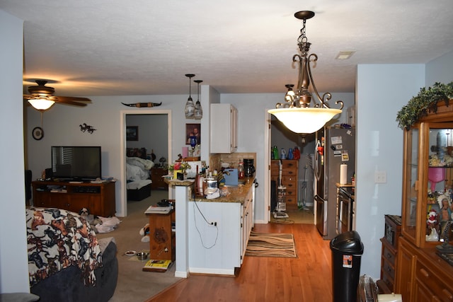185 Cave Run Dr Unit 5, Erlanger, KY 41018 - kitchen featuring white cabinetry, light wood-type flooring, a ceiling fan, and decorative light fixtures