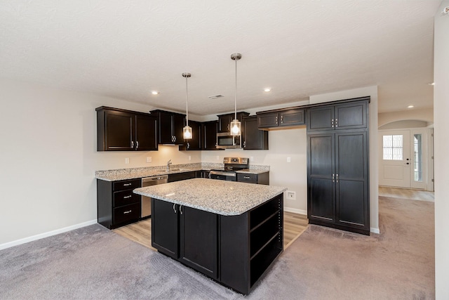 2535 Crosshill Dr, Crescent Springs, KY 41017 - kitchen with stainless steel appliances, light colored carpet, open shelves, arched walkways, and baseboards