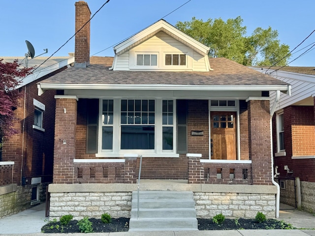 618 E 2nd St, Newport, KY 41071 - view of front facade featuring a porch, roof with shingles, and brick siding