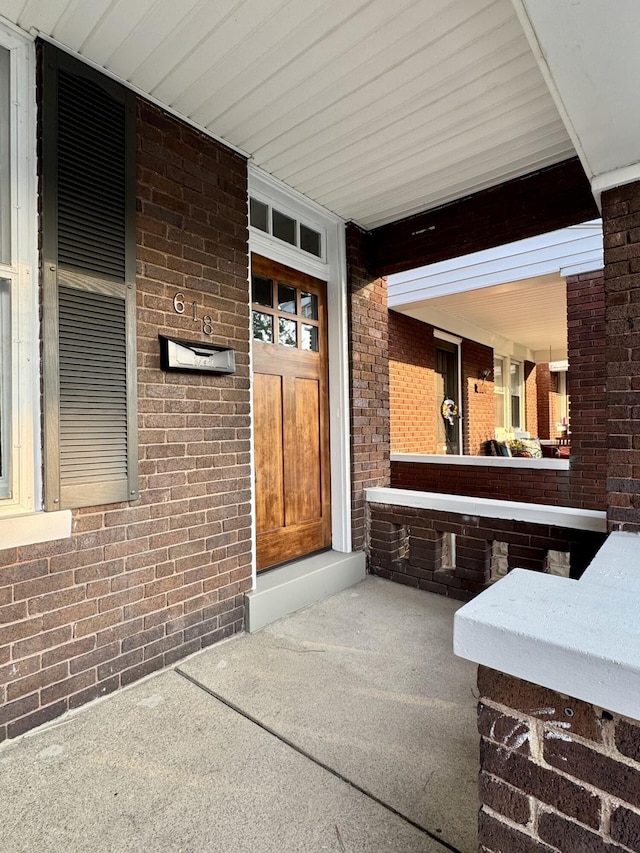 618 E 2nd St, Newport, KY 41071 - doorway to property featuring covered porch and brick siding