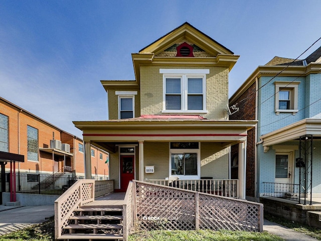 1816 Scott St, Covington, KY 41014 - victorian house featuring a porch, brick siding, and central air condition unit