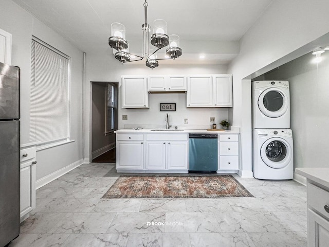 1816 Scott St, Covington, KY 41014 - kitchen with dishwasher, stacked washing machine and dryer, a sink, light countertops, and a chandelier