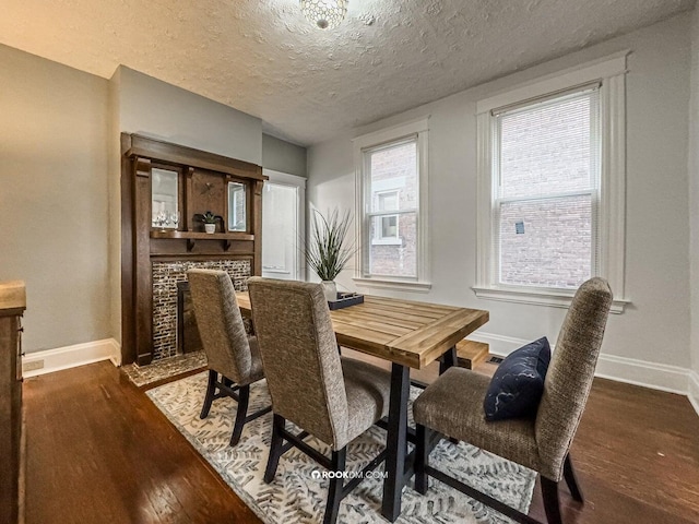 1816 Scott St, Covington, KY 41014 - dining area with baseboards, dark wood-type flooring, and a textured ceiling
