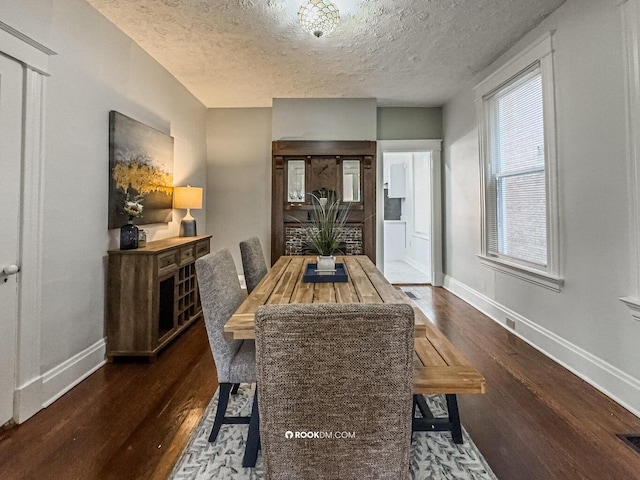 1816 Scott St, Covington, KY 41014 - dining area featuring wood finished floors, baseboards, and a textured ceiling
