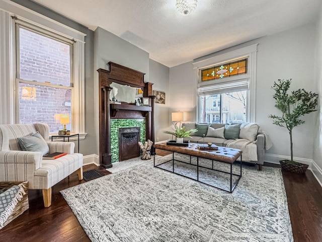 1816 Scott St, Covington, KY 41014 - living room featuring dark wood finished floors, a fireplace, and baseboards