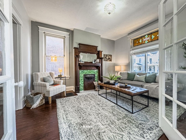 1816 Scott St, Covington, KY 41014 - living room featuring dark wood finished floors, plenty of natural light, a fireplace, and a textured ceiling