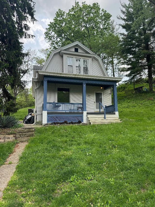 1148 Park Ave, Newport, KY 41071 - colonial inspired home featuring a gambrel roof, a front yard, and a porch
