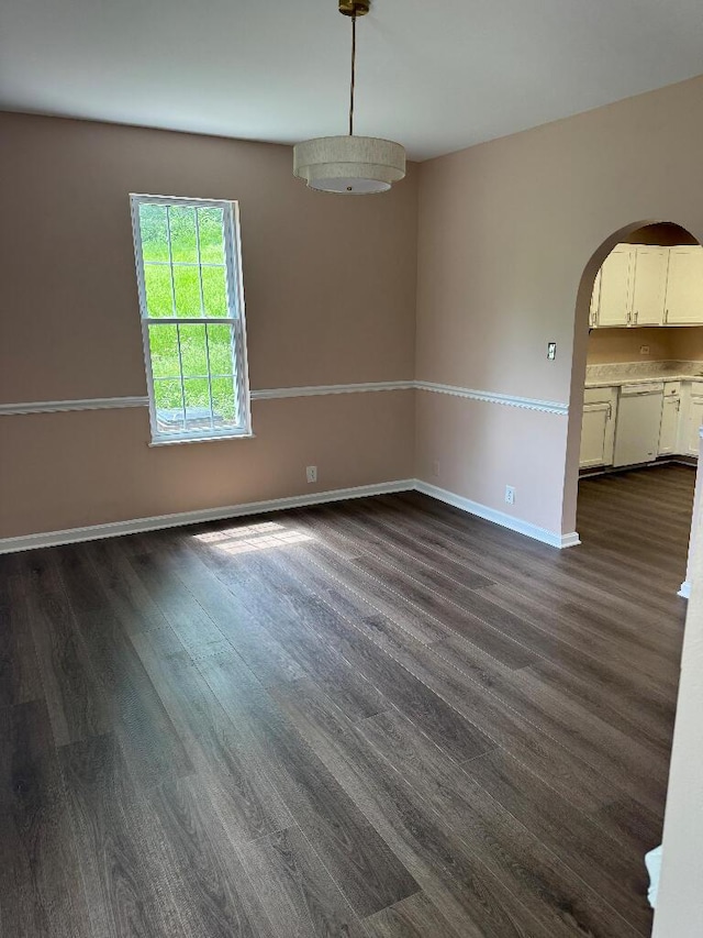 1148 Park Ave, Newport, KY 41071 - spare room with dark wood finished floors, arched walkways, and baseboards