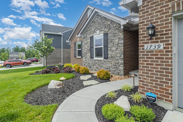 1739 Barons Cv, Hebron, KY 41048 - view of property exterior featuring stone siding, a lawn, and brick siding