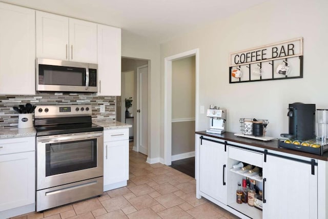 3416 Meadowlark Dr, Edgewood, KY 41018 - kitchen with appliances with stainless steel finishes, decorative backsplash, white cabinets, and light stone countertops