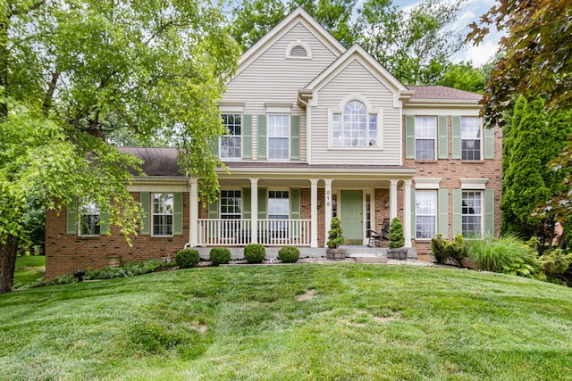 816 Winterberry Ct, Villa Hills, KY 41017 - view of front facade featuring covered porch, brick siding, and a front yard