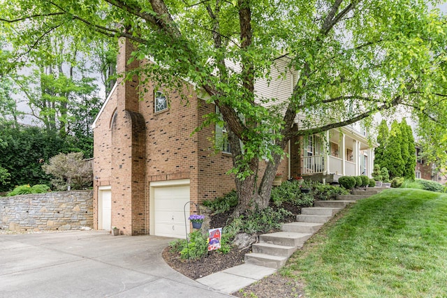 816 Winterberry Ct, Villa Hills, KY 41017 - view of front of home featuring driveway, an attached garage, brick siding, stairs, and a front yard