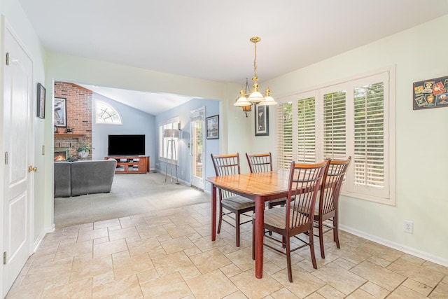 816 Winterberry Ct, Villa Hills, KY 41017 - dining room with stone tile floors, vaulted ceiling, a fireplace, and baseboards