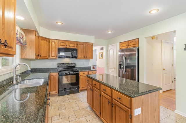 816 Winterberry Ct, Villa Hills, KY 41017 - kitchen with black appliances, a sink, dark stone countertops, a center island, and brown cabinetry