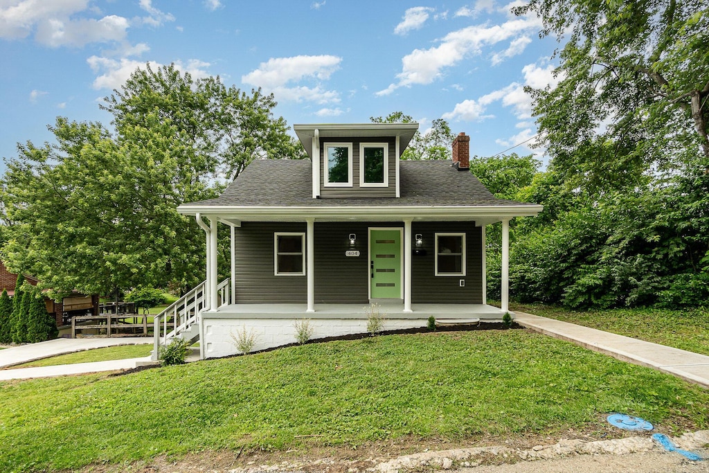 404 Locust St, Erlanger, KY 41018 - view of front of house featuring a chimney, covered porch, a front yard, and roof with shingles