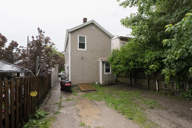 622 W 12th St, Covington, KY 41011 - rear view of property featuring a fenced backyard and a chimney