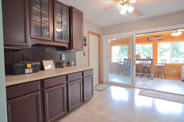 445 Elk Lk Lot 945/946, Owenton, KY 40359 - kitchen featuring healthy amount of natural light, a ceiling fan, glass insert cabinets, light countertops, and wooden walls