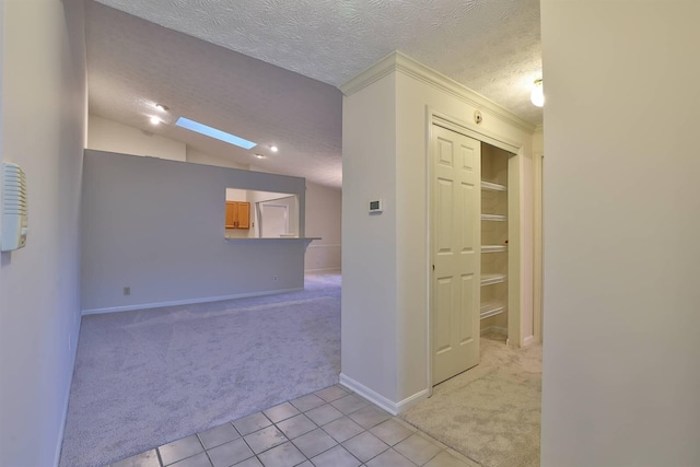 328 Deepwoods Dr, Highland Heights, KY 41076 - corridor featuring light carpet, light tile patterned floors, a textured ceiling, baseboards, and crown molding