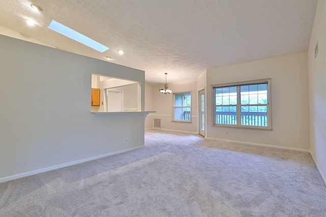 328 Deepwoods Dr, Highland Heights, KY 41076 - spare room with a chandelier, light colored carpet, a skylight, a textured ceiling, and baseboards