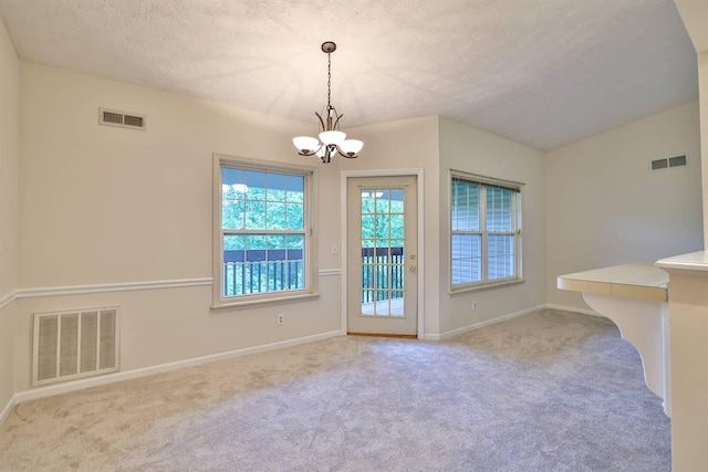 328 Deepwoods Dr, Highland Heights, KY 41076 - unfurnished dining area with a chandelier, carpet flooring, baseboards, and a textured ceiling