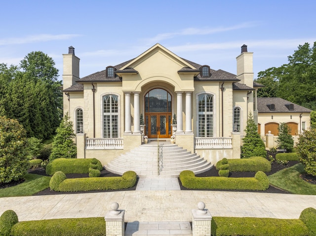 943 Squire Oaks Dr, Villa Hills, KY 41017 - french country inspired facade with french doors, a chimney, and stucco siding